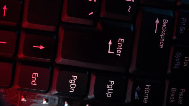 istock The computer keyboard, which is shot close to the abstract lights, is pressed at the enter. 1204399310