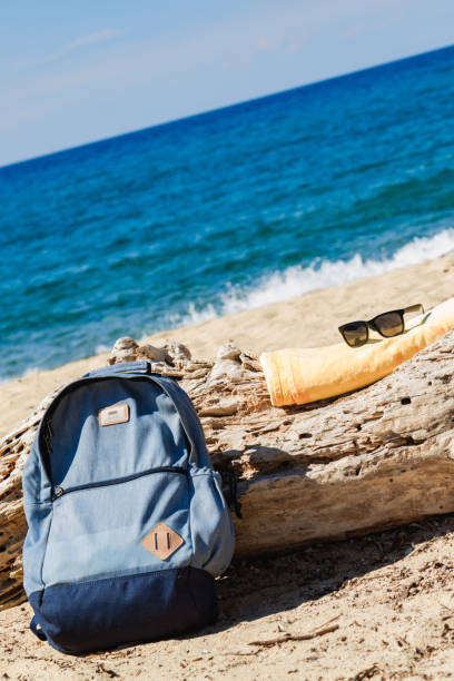 istock Tourist rucksack on a sandy tropical beach. 1204400807