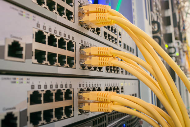 istock Communication equipment is in the server room of the data center. Network Ethernet patch cords are included in the interfaces of routers. Many yellow utp wires connect to internet switches 1204400861