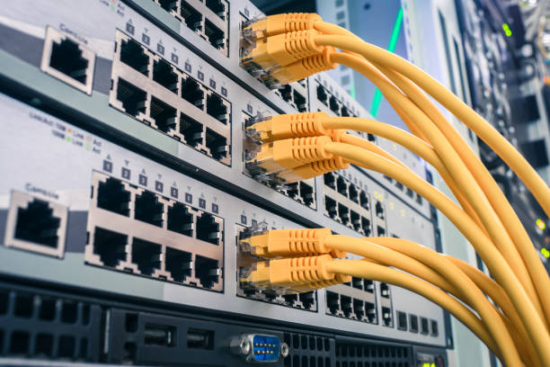 istock A bunch of yellow communication cables connect to the router interfaces. Telecommunication equipment is in the server room of the data center. Technology concept 1204400912