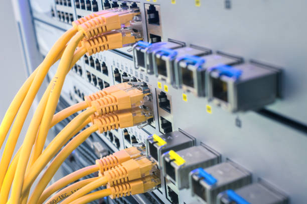istock Technology concept. Telecommunication equipment is in the server room of the data center. Interent utp wire. A bunch of yellow communication cables connect to the router interfaces. 1204400937