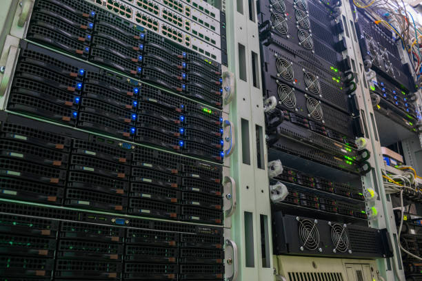 istock Racks with powerful servers are in the data center. The computer equipment of the Internet provider is in the server room. Hosting platform of a modern technology company. View from the bottom 1204401000