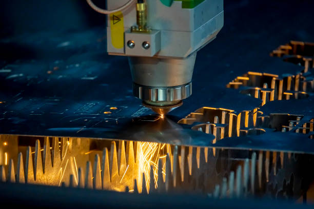 The close up scene of fiber laser cutting machine cutting the sheet metal  plate. stock photo