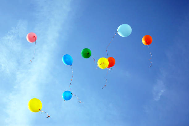 istock colored balloons flying in the blue sky 1204403165