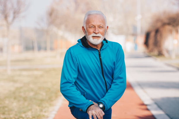 istock A senior man stretching legs in the park. 1204404974