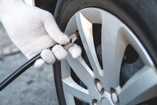 istock Self Pumping car tires. People at work. 1204405547