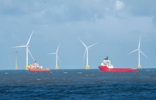 Offshore wind turbines off the Aberdeen coast in Scotland A group of tall offshore wind turbines in the North Sea, with cargo ships alongside them. These energy producing turbines are located off coastline of Aberdeen, on the east coast of Scotland. The renewable energy producers are an alternative to fossil fuel production, in an attempt to reduce the long term impact on our environment. They show a changing seascape along certain areas of the UK coastline, with shipping having to navigate around the manmade structures. aberdeen scotland photos stock pictures, royalty-free photos & images