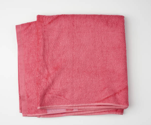 istock folded bath terry pink towel on a white background 1204407819