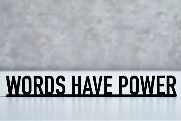 Phrase WORDS HAVE POWER on gray background