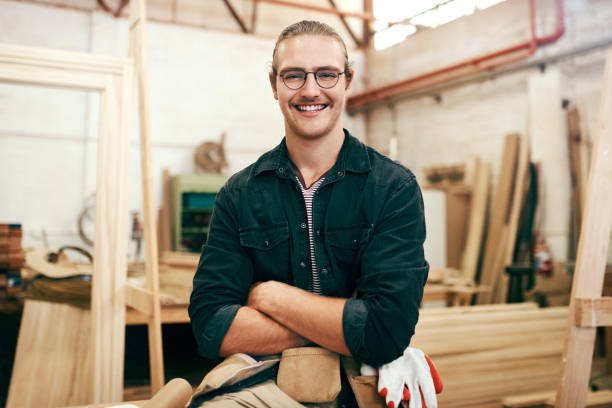 I’m an expert in this field Portrait of a handsome young carpenter posing with his arms folded inside his workshop carpenter portrait stock pictures, royalty-free photos & images