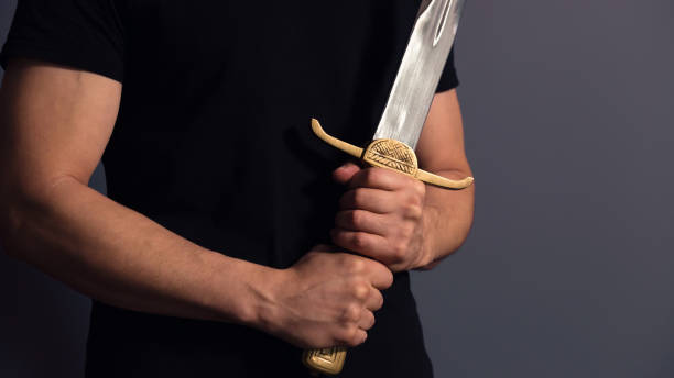 istock Young Athletic Man Holding His Sword 1204410027