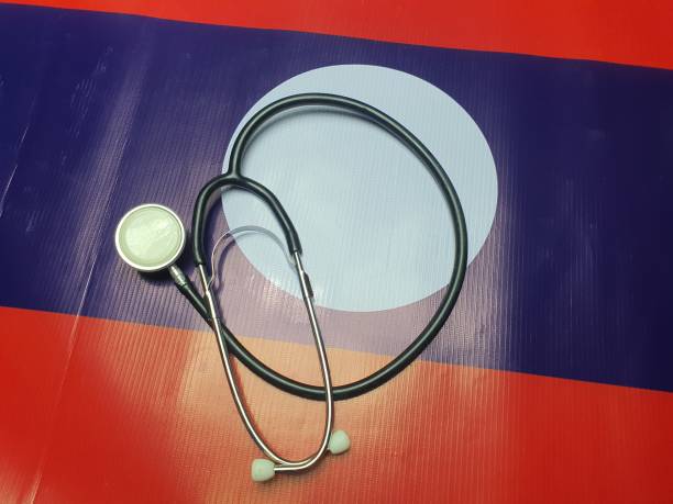istock Medical stethoscope is placed on the Laos flag, a background. 1204410035