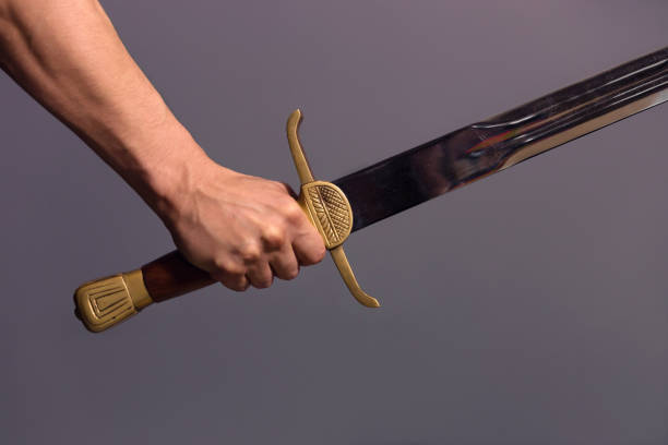 istock Young Athletic Man Holding His Sword 1204410090