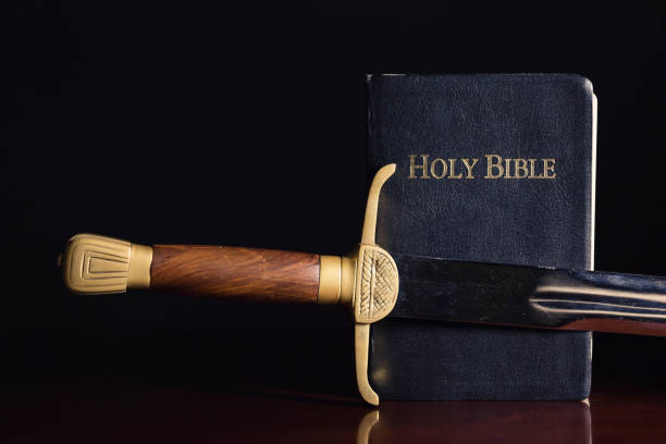 istock The Holy Bible with Ancient Sword 1204410150