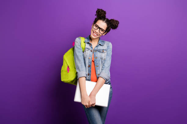 Portrait of sweet cute girlish high school girl ready for university seminar lecture hold computer wear casual style outfit isolated over violet color background Portrait of sweet cute girlish high school girl ready for university seminar lecture, hold computer wear casual style outfit isolated over violet color background topknot stock pictures, royalty-free photos & images