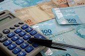 Brazilian money, calculator and pen. Economy concept.