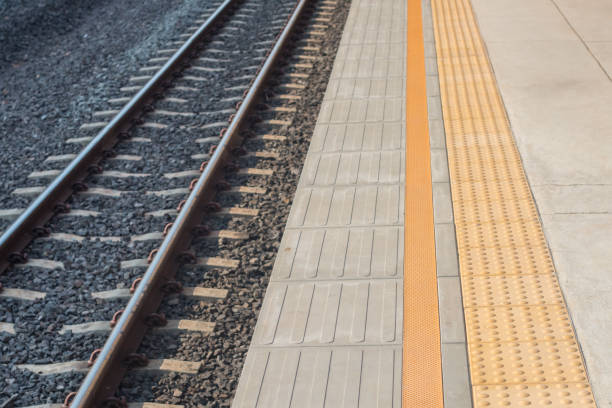 istock Railway and walkway in train station 1204414296