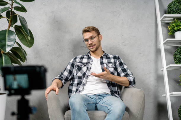 istock Young adult blogger creating internet video content 1204414766