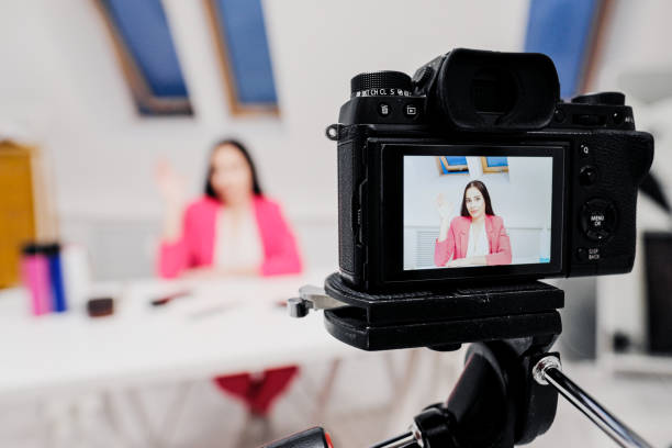 istock Female vlogger freelancer streams. The camera is close-up. View through the camera screen. 1204414807