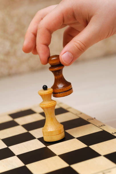 istock pawn winning queen in a chess game 1204414856