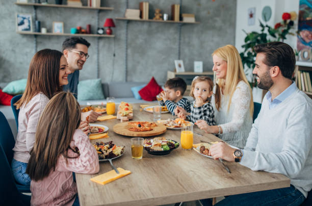 istock Two families having lunch together at home 1204416848