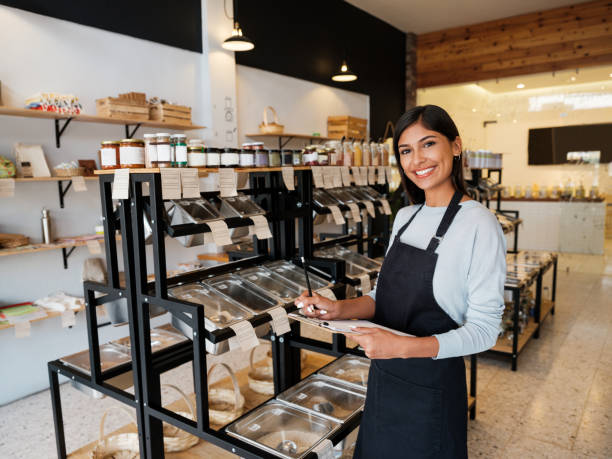 istock Happy employee in eco-friendly shop standing with chart 1204417192