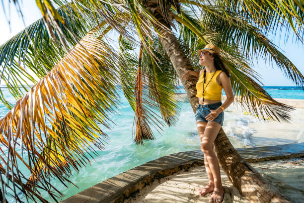 istock Woman leaning on palm by sea 1204420005