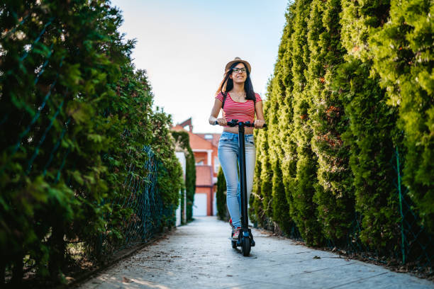 istock Young woman driving electric scooter 1204421412