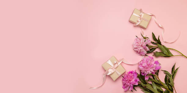 istock Surprise gift box with pink peonies flowers with copyspace, flat style, view from above 1204421483