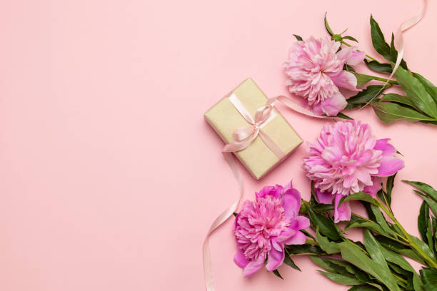 istock Surprise gift with peonies flowers, view from above 1204421494