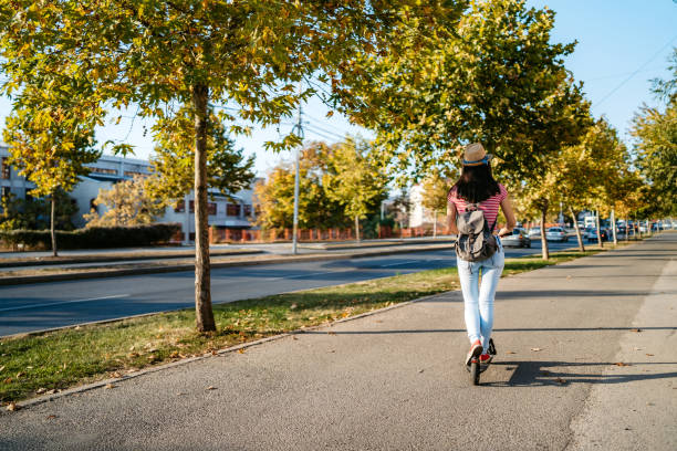 istock Young woman driving electric scooter 1204421546