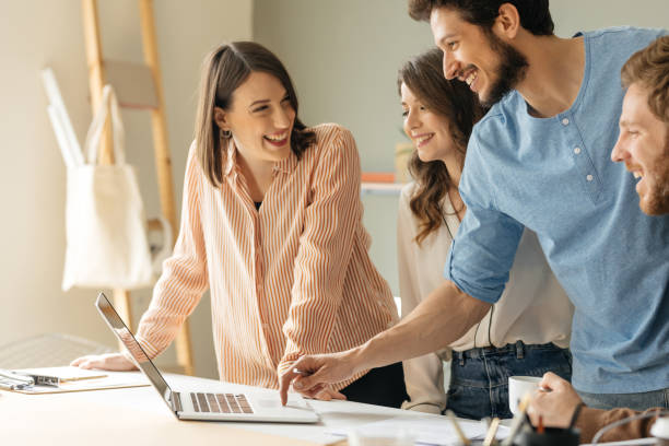 istock Smiling Businesspeople Working on a Laptop 1204422173