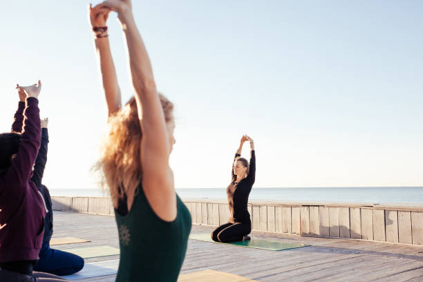 istock group of sporty people practicing yoga 1204423489