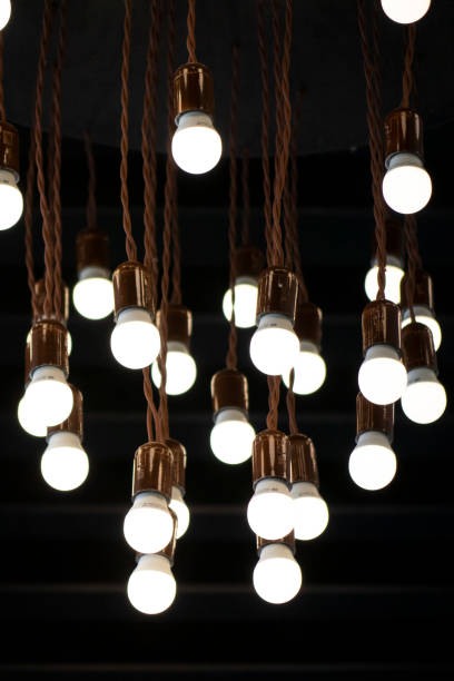 istock Lots of light bulbs on a dark background. 1204424070
