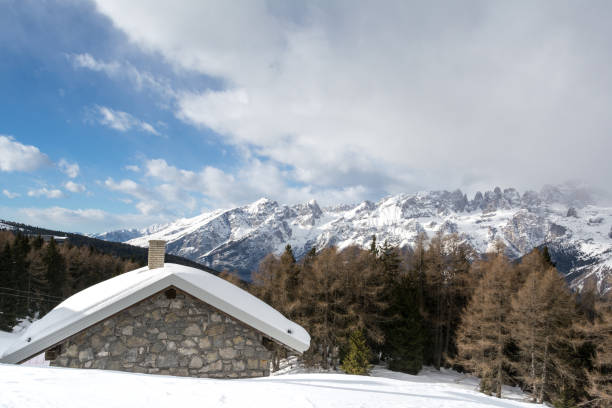 istock cottage covered with snow, Andalo,Dolomites 1204424072