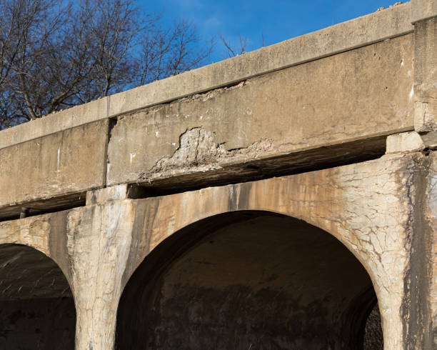 istock Old rural railroad bridge with crumbling, cracking concrete. Concept of deteriorationg transportation infrastructure in the United States of America 1204424708