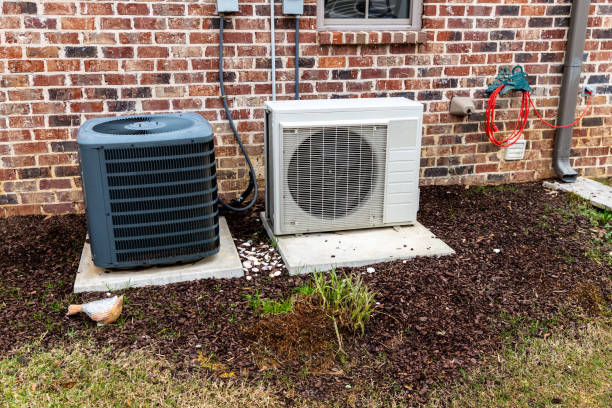 istock Mini-split air conditioner unit and full Compressor next to home, with copy space 1204424759