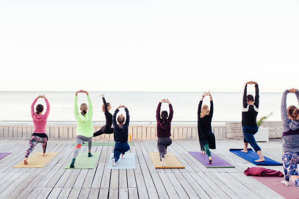 istock group of sporty people practicing yoga 1204424802
