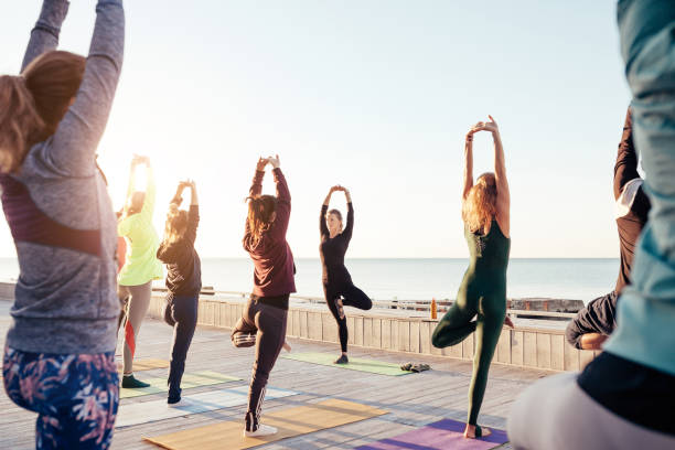 istock group of sporty people practicing yoga 1204424943