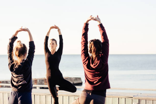 istock group of sporty people practicing yoga 1204425010