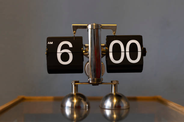 istock Mechanical analog vintage flip clock - showing 6.00 am 1204425611