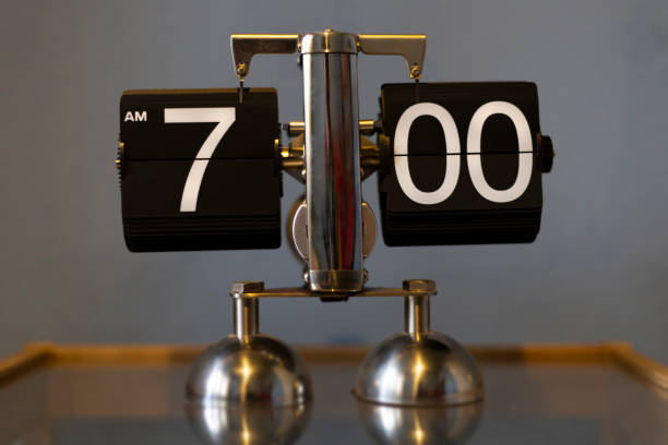 istock Mechanical analog vintage flip clock - showing 7.00 am 1204425651