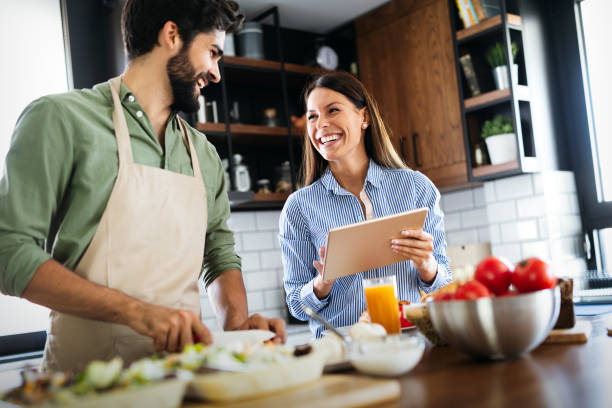 istock Happy couple cooking together in their kitchen 1204426566