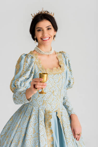 istock smiling queen with crown holding cup isolated on grey 1204426877