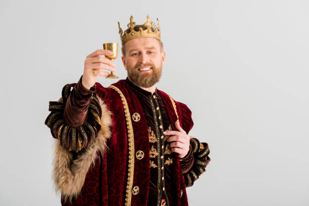 istock smiling king with crown holding cup isolated on grey 1204426920