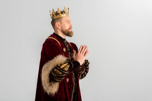istock side view of king with crown praying isolated on grey 1204426925