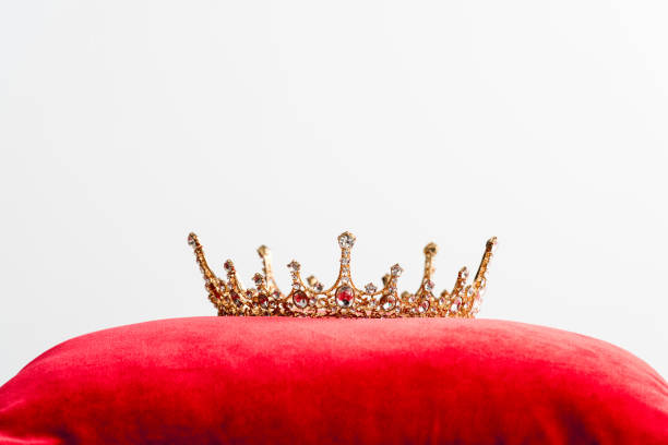 istock royal crown on red pillow isolated on white with copy space 1204426954