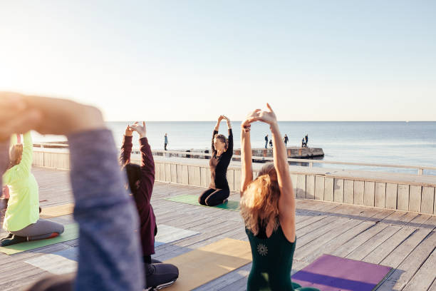 istock group of sporty people practicing yoga 1204426980
