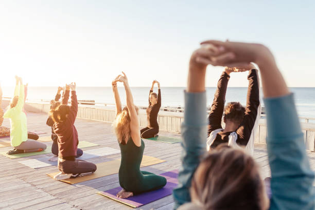 istock group of sporty people practicing yoga 1204427033