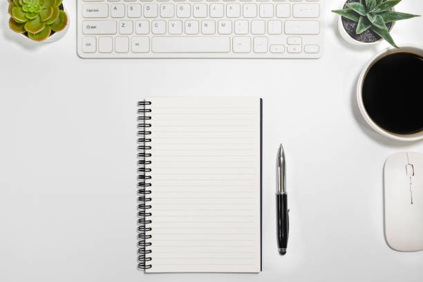 istock Flat lay, White office desk table. View from above with keyboard, computer mouse, plant potted, succulents and cup of black coffee. Top view with copy space. Business concept. 1204427035
